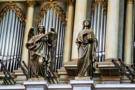 Shot of metalic statues near organ in cathedralの写真素材