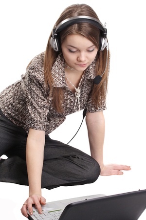 Image of a girl in headset with notebookの写真素材
