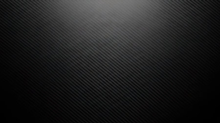 This image presents a seamless carbon fiber texture in black. The pattern features diagonal lines creating a three-dimensional effect. The lighting suggests a subtle overhead source, enhancing the texture's depth. It has potential uses in various commercial and design projects.の素材