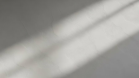 This image presents a study of light and shadow, with diagonal lines creating a dynamic composition. The soft gray tones contribute to a minimalist aesthetic. This visual could be utilized in design projects or as a background. The subtle textures and lighting offer versatility for various commercial applications.の素材