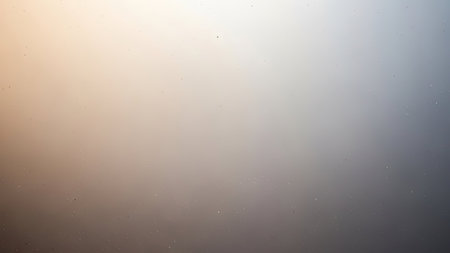 This abstract image presents a smooth gradient transition, featuring a blend of warm and cool tones. The composition is simple, with an emphasis on color and texture. Its soft lighting creates a subtle atmosphere, ideal for various commercial and editorial applications such as website backgrounds or print design.の素材