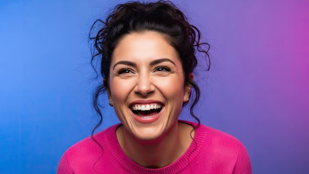 A woman is shown with a large smile against a gradient background, suggesting a studio setting. The close-up showcases a face with open eyes. This image could be used for advertising, editorial projects, or website designs. The composition has bright colors and high contrast.の素材