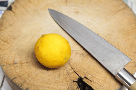 lemon and knife on a cutting board in the kitchen preparing food Thailand の写真素材