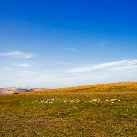 Seven sisters cliffs at English chanel coast, East Susex, England. July 2014: The inscription "Free wi-fi" on the grass lined with white stone, UK, Circa July 2014.の写真素材