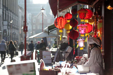 LONDON, UK - MAY 30, 2015: People walk along a busy shopping street in London's Chinatown. Over 120,000 people of Chinese ethnicity live in the British capital, 33% of the UK's Chinese population.のeditorial素材