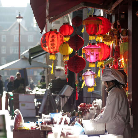 LONDON, UK - MAY 30, 2015: People walk along a busy shopping street in London's Chinatown. Over 120,000 people of Chinese ethnicity live in the British capital, 33% of the UK's Chinese population.のeditorial素材
