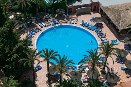 Benidorm, Spain - SEP 20, 2014: view of swimming pool and colorful hotel buildings on sunny summer day, Benidorm, Spainのeditorial素材