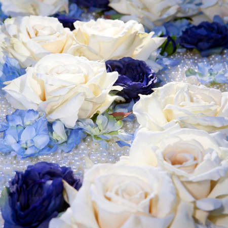artificial white and blue roses on pearl beadsの写真素材