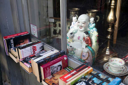 London, UK -MAY 4:  Antique Market Buddha and Mao red books and Buddha on sale.  May 4, 2015 lONDON, UKのeditorial素材