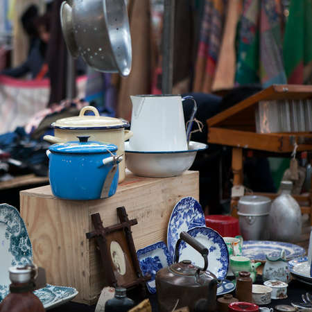 London - January 17, 2014. Flea market with old-fashioned goods displayed in London city, UK. On 17 January 2014. Messy packed room full of antique objects like utensils, tea-pot, cap, vaseのeditorial素材