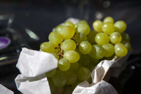 Green grapes in paper bag. Selective focusの写真素材