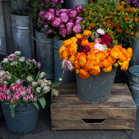 Spring bouquet with orange and white ranunculus and anemones in bright colorsの写真素材