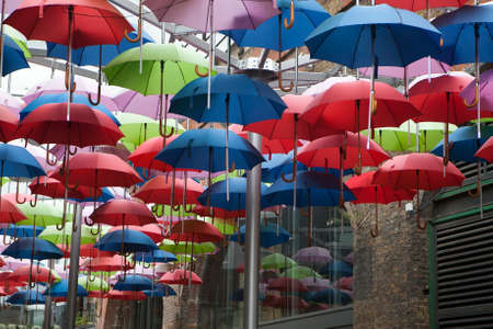 LONDON - NOV 6: Exterior of pub, for drinking and socializing, focal point of the community, on Nov 6, 2010, London, UK. Pub business, now about 53,500 pubs in the UK, has been declining every year. Umbrella as a cover from rainのeditorial素材