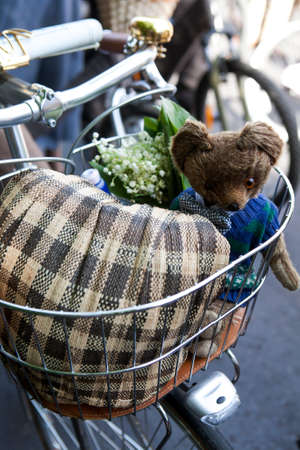 flower and vintage teddy bear in the bicycle basketの写真素材