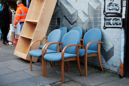 London - January 17, 2015. Collection of old broken chairs on the flea market. Flea market with old-fashioned goods displayed in London city, UK. On 17 January 2015.のeditorial素材