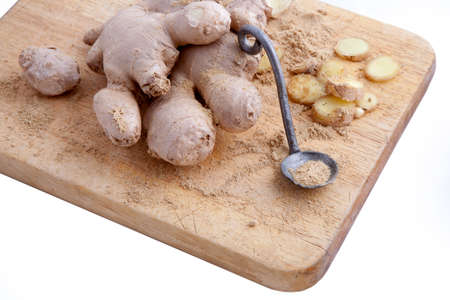 Close up of different forms of ginger against a wood worktopの写真素材