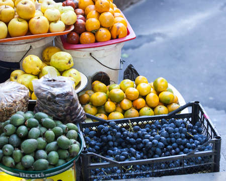 grapes, quince, tangerines, figs in containers for sale in a vegetable shop in Tbilisiの写真素材