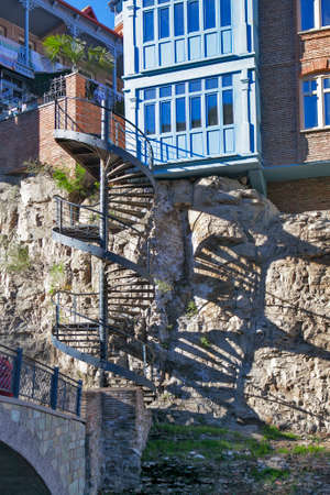 TBILISI, GEORGIA, 16 AUGUST, 2016: Traditional georgian architecture with wooden balconies in Abanotubani historical part of Tbilisi near waterfall in botanical garden.Georgia, unesco heritageのeditorial素材