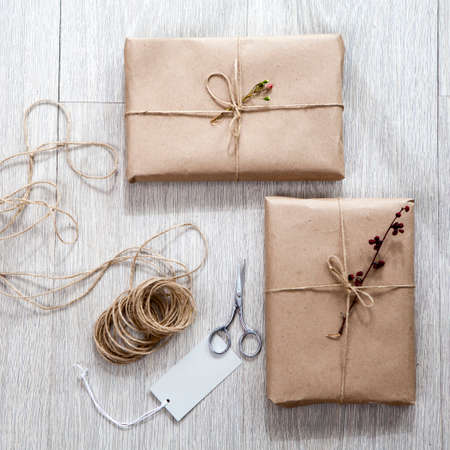 Various items for gift wrapping are on the table. Gifts already packed