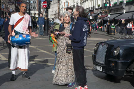 LONDON, UK - MAY 21, 2016: Hare Krishna Devotees walk in the street in London, UK