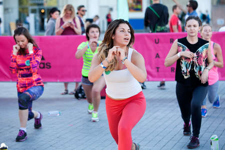 Moscow, RUSSIA - June 23, 2016: Girl with adidas logo on the hand doing exercise ,  listening to the...