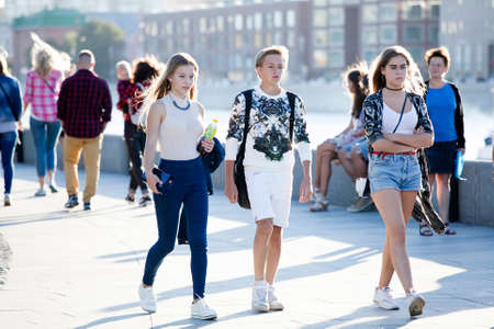 Moscow, RUSSIA - June 23, 2016: Cultural diversity in Moscowy - teens walking the waterfront promenade in sunsetting lightのeditorial素材