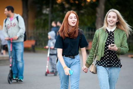 Moscow, RUSSIA - June 23, 2016: Cultural diversity in Moscowy - teens walking the waterfront promenade in sunsetting lightのeditorial素材