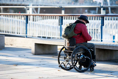 LONDON, ENGLAND - JULY 12, 2016 Tourist in wheel chair wheelchair at Southbankのeditorial素材