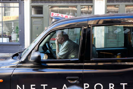 LONDON, ENGLAND - JULY 12, 2016 The taxi driver waiting when the traffic light turns green lightのeditorial素材
