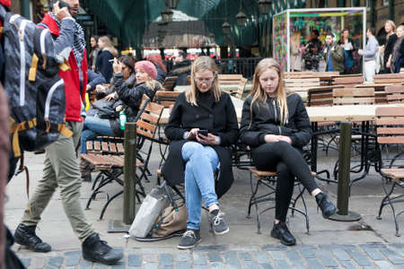 LONDON, UK - APRIL 22, 2016: Blond Mother and daughter look the same sitting at the cafe at Covent Gardenのeditorial素材