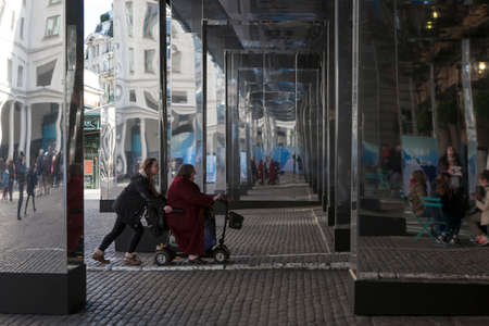 LONDON, UNITED KINGDOM - JANUARY 16, 2016: Unidentified people in front of Covent Garden market hall. pushes a wheelchair with her grandmotherのeditorial素材