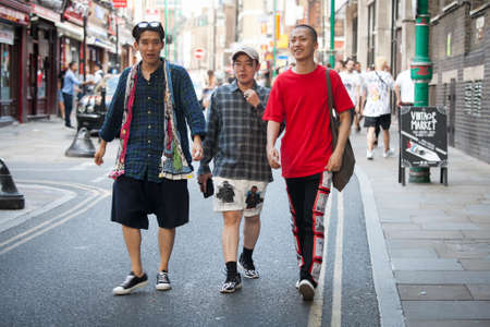 LONDON, ENGLAND - JULY 12, 2016 hipster men dressed in cool Londoner style walking in Brick lane, a street popular among young trendy peopleのeditorial素材