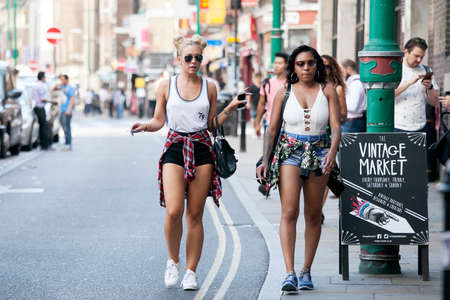 LONDON, ENGLAND - JULY 12, 2016 hipster gilrs dressed in cool Londoner style walking in Brick lane, a street popular among young trendy peopleのeditorial素材