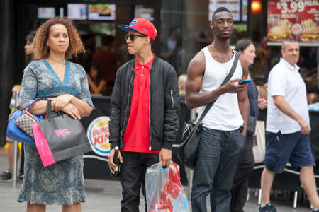 LONDON, ENGLAND - JULY 12, 2016 A motley crowd waiting at a pedestrian crossing, intending to cross the roadのeditorial素材