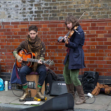 LONDON, UK - APRIL 22, 2016: Street musician play electric guitar near Columbia Road Flower Market. Dozens buskers perform on the streets of London.のeditorial素材