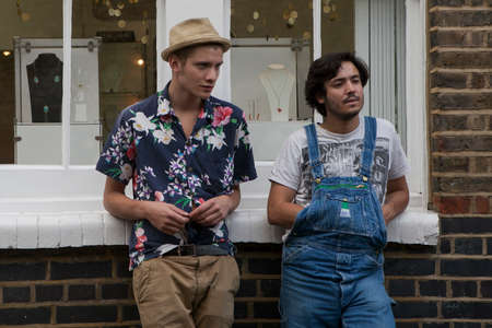 LONDON, ENGLAND - JULY 12, 2016 Sunday flower Columbia road flower market. The local going for flower, sitting on sidewalks, drink wine, eat and listen to the street musicians. Some of them dancing.のeditorial素材