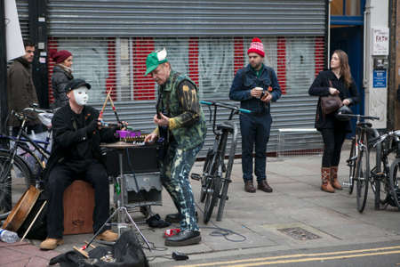 LONDON, UK - APRIL 22, 2016: LONDON, ENGLAND - JULY 12, 2016 Shoreditch, London: street musicians at Columbia Road flower marketのeditorial素材