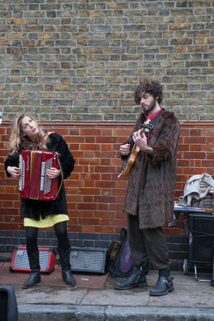 LONDON, UK - APRIL 22, 2016: LONDON, ENGLAND - JULY 12, 2016 Shoreditch, London: street musicians at Columbia Road flower marketのeditorial素材