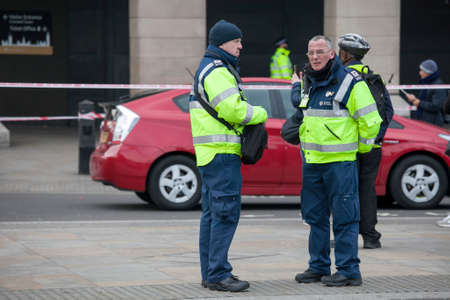 London, UK Thursday March 23, 2017 Police officers stand guard on a road leading to the Houses of...