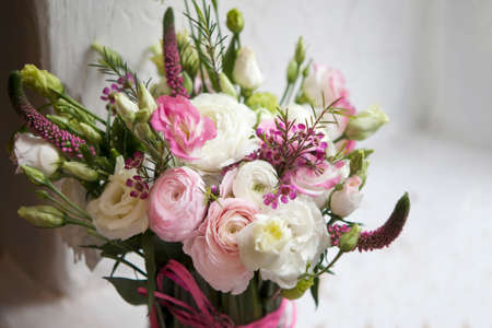 Spring bouquet of pink Ranunculus, lisianthus and Veronica for a special wedding ceremony. Copy...