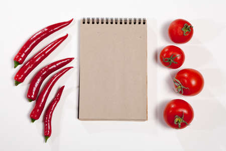 Postcards for recipes. Sketchpad and red hot pepper as a frame on a white background.