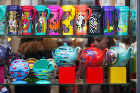 LONDON, ENGLAND - March 12, 2017 Multicolored thermoses, mugs and trays in the shop windowのeditorial素材