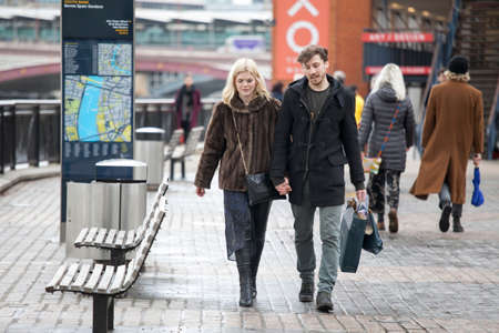 LONDON, ENGLAND - March 12, 2017 A happy couple, holding hands, walking along the waterfrontのeditorial素材
