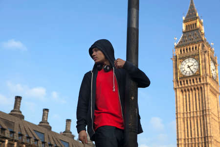 London, UK. 19th Nov, 2016. Students protest against fees and cuts and debt in central London. A man in red T-shirt on post on the background of Big Benのeditorial素材