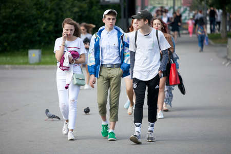 Moscow, RUSSIA - June 23, 2017: Cultural diversity in Moscowy - teens walking the waterfront promenade in sunsetting lightのeditorial素材