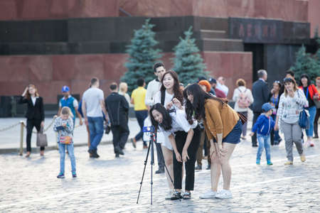 Moscow, RUSSIA - June 23, 2017: Asian tourists put a tripod on Red Square and shoot a video.のeditorial素材