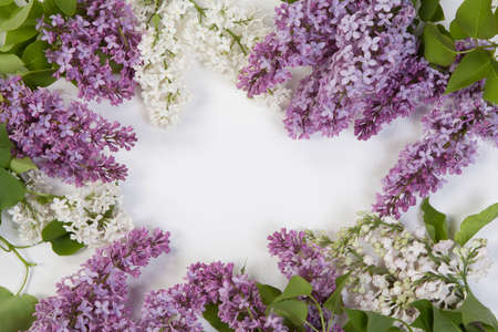 Spring frame with blue and white flower of lilac. Frame of beautiful flowers on a white wooden surface. Vintage toning. With copy-spaceの写真素材