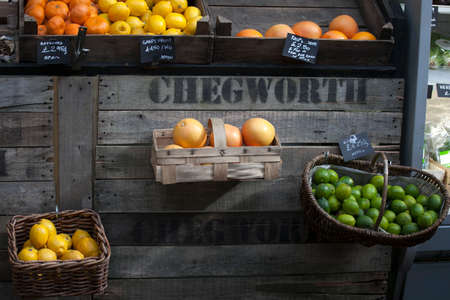 LONDON, ENGLAND - August 11 2017, the Lime, orange, tagerine, grapefruit in a wicker box that hangs on the wall, for sale on the Borough marketのeditorial素材