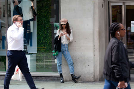 LONDON, ENGLAND - August 11 2017. People walk near Covent Garden. Curly girl stands near entrance to shopのeditorial素材