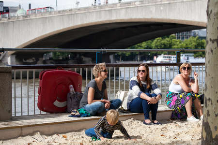 LONDON, ENGLAND - August 11 2017 Children play in the sand on the beach on the South Bank, London; part of the Festival of Britain anniversary celebrationsのeditorial素材